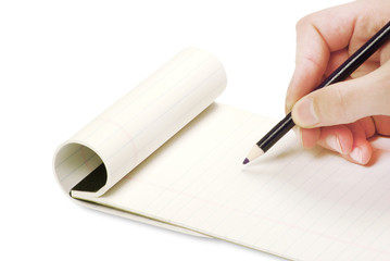 Pencil in hand writing on the notebook
