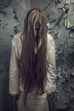 zombie girl with loong hair in an abandoned building