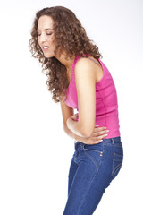 Young woman with stomach pains in studio...