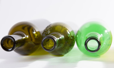 three empty wine bottles lying