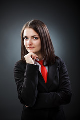 Young businesswoman thinking isolated on gray  backgound