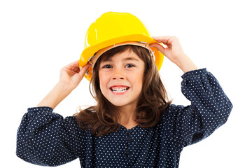 Beautiful little girl wearing construction helmet