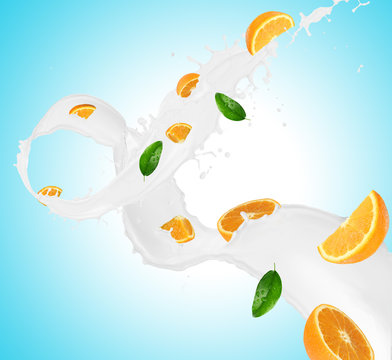 Pieces of oranges in milk splash
