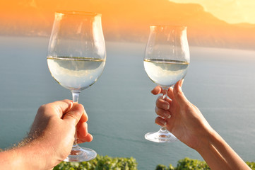 Two hands holding wineglases