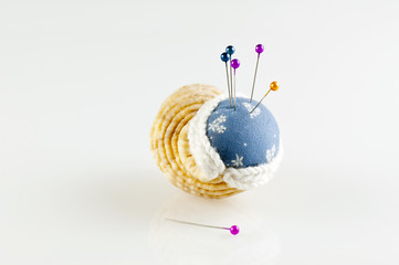 pincushion in shell with pins isolated horizontal