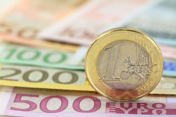 Euro coin against euro notes. Shallow DOF on coin - 45437125