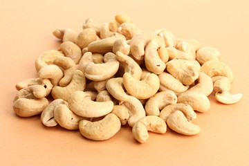 tasty cashews nuts, on beige background