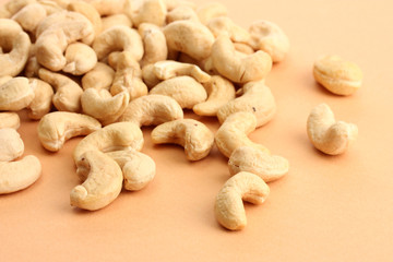 Fototapeta na wymiar tasty cashews nuts, on beige background