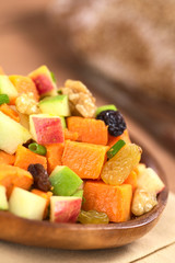 Salad made of sweet potato, apple, nut, raisin, shallot
