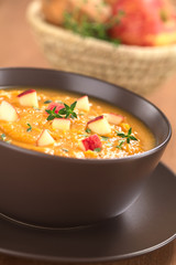 Bowl of fresh sweet potato and apple soup with thyme