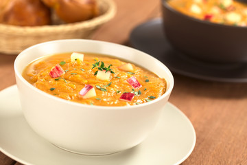 Two bowls of sweet potato and apple soup with thyme