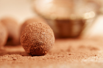 chocolate truffles cocoa powder dusted and sieve, shallow dof