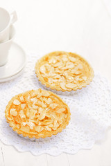 almond tarts on wooden white table