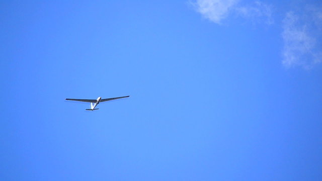 Glider isolated against blue sky