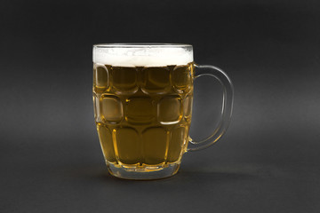 Mug of beer on black background