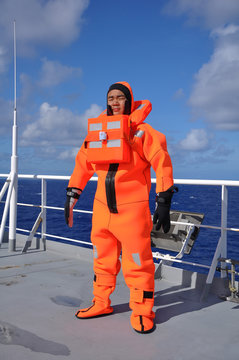 seaman in immersion suit and life jacket