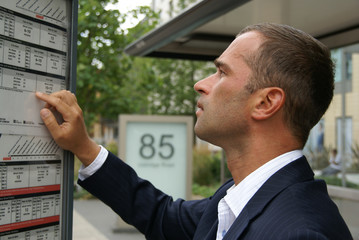 Man checking a bus timetable