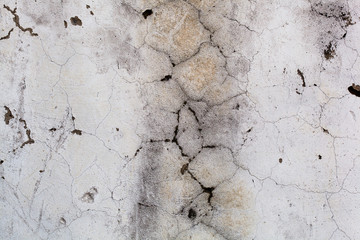 The gray concrete wall in the cracks  Abstract, close-up
