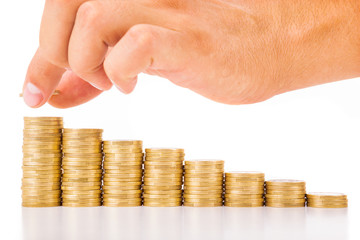 Hand put coin to money staircase , isolated on white