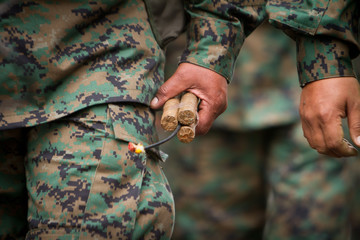 soldier holding  dynamite with fuse