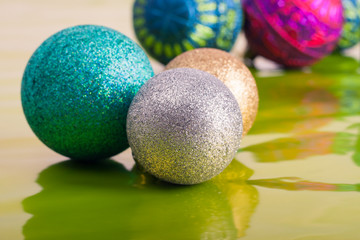 Christmas balls on green background