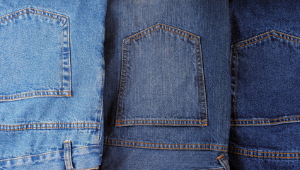 set of different kind of blue jeans, as background