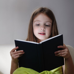 beauty girl read book on sofa