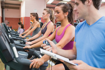 Instructor with stopwatch in gym