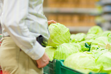 Customer select cabbage in supermarket