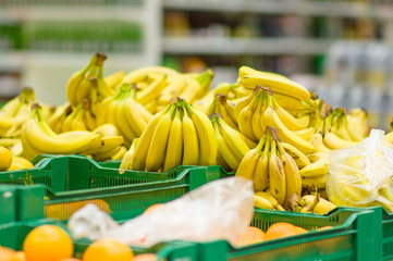 Bunch of bananas in boxes in supermarket