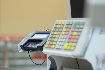 Cash-desk with cashier and terminal in supermarket