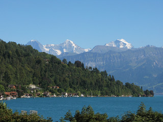 Fototapeta na wymiar Famous Eiger, Moench and Jungfrau mountain peaks and the lake Th