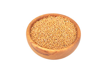 Mustard seeds in wooden bowl, isolated on white background