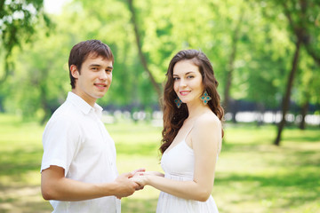 Young love Couple smiling under blue sky