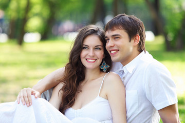 Obraz premium Young love Couple smiling under blue sky