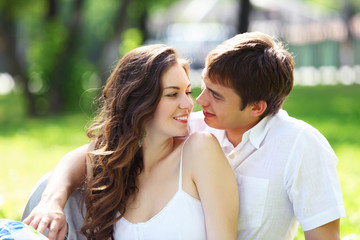Fototapeta premium Young love Couple smiling under blue sky