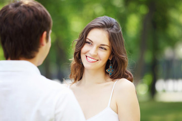 Obraz premium Young love Couple smiling under blue sky