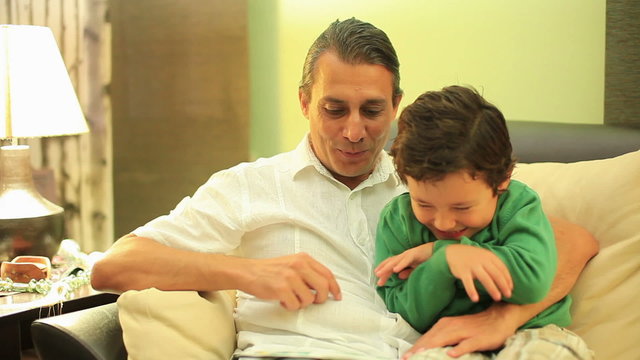 father and son reading a book