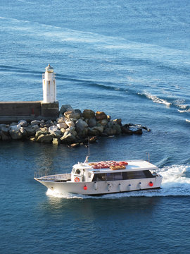 Pleasure boat entering port of Camogli, Italy