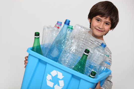 Child recycling plastic bottles
