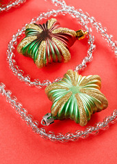 Christmas decoration stars and silver tinsel on red background
