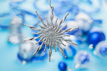 Christmas star bauble over blurred blue background