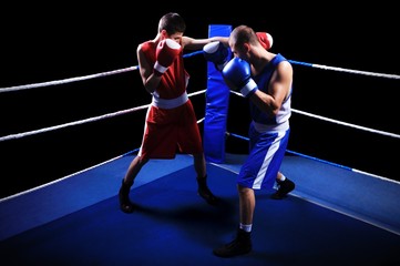 Two male boxers fighting in ring