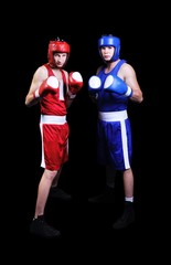 Obraz premium Two male boxers fighting on black background