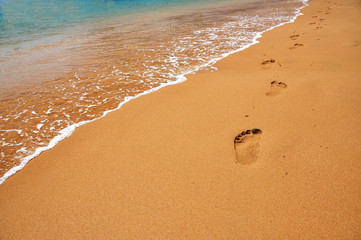 Footmarks on a sandy beach ..