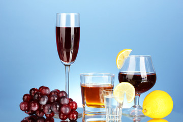 a variety of alcoholic drinks on blue background