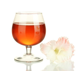 glass with cocktail and gladiolus bud isolated on white