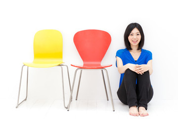 a young asian woman with colorful chair