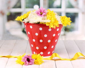 Red pail of peas with flowers