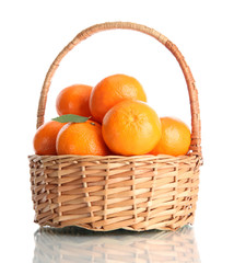 tangerines with leaves in a beautiful basket isolated on white